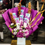 Purple Floral Bouquet with Wrapped Gifts & Golden Accents