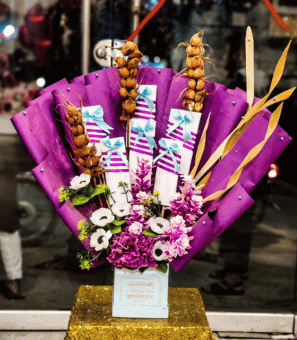 Purple Floral Bouquet with Wrapped Gifts & Golden Accents